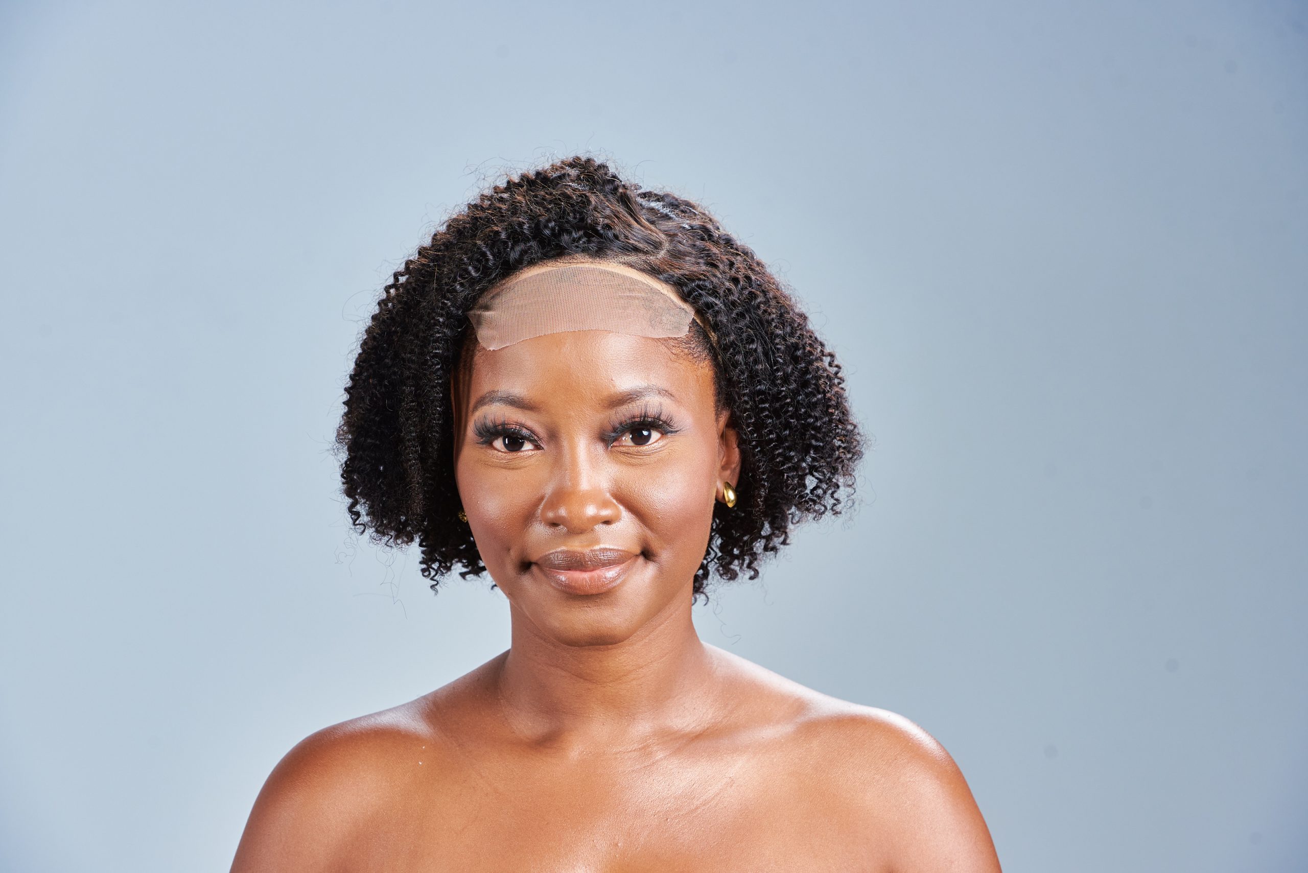 The Beautiful Market Glueless 5 x 5 Lace Closure Wig with Kinky Curly Side Part. It's fuller density, pre-plucked, natural black and is 10 inches